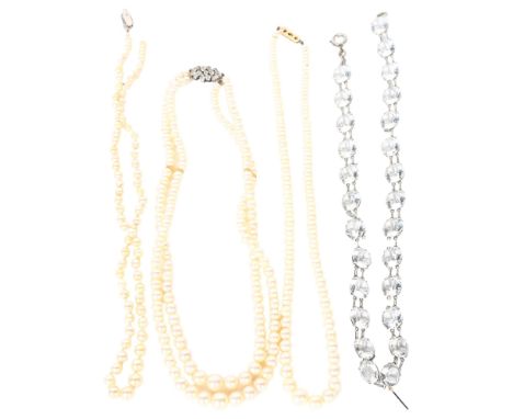 A simulated double-string pearl necklace with paste set clasp, length 79cm, and a graduated cultivated single-strand pearl ne