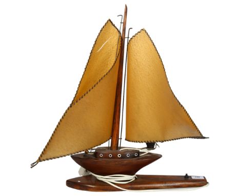 A wooden sailing ship design table lamp, H55cm1 of the ship's sails has a split through it near the top from 1 side to the ot