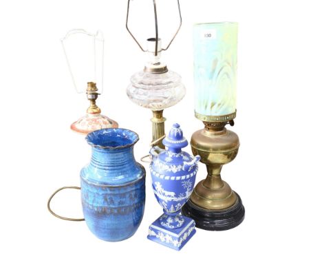 A brass oil lamp, with an unassociated yellow vaseline glass shade, another oil lamp with glass font, a Chinese style table l