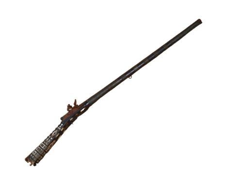 An Antique Indian musket of incomplete form, engraved and brass-bound barrel with mother-of-pearl and studded decorated stock