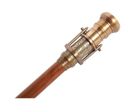 A gadget top walking cane, the handle comprising of a compass and hidden magnifying glass, L98cm 