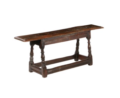 The moulded rectangular top above channel moulded rails,  on baluster ring-turned legs joined by plain stretchers, 126cm wide