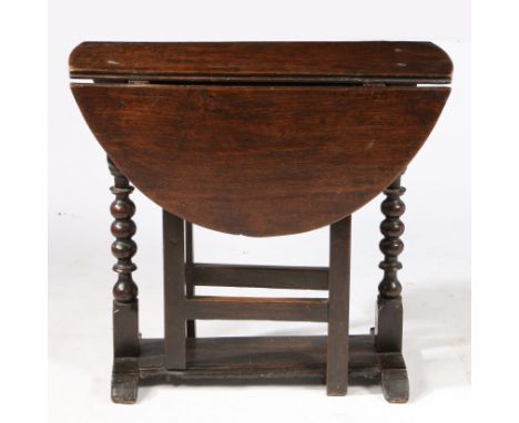 The oval drop-leaf top formed from one-piece boards, on ball-turned end-supports, on sledge feet joined by a broad edge-mould