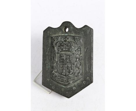 The central Royal coat of arms and W R above, the edge with a hole for the tronators strap and ring to the arched top and sta