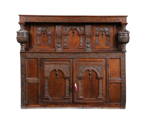 With S-scroll leaf-carved frieze on large bulbous gadrooned and strapwork leaf-carved columns, enclosing a pair of arched scr