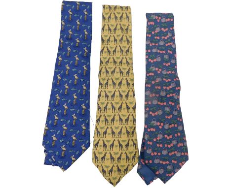 Three Hermes silk ties, comprising a blue tie with baskets of cherries, yellow tie with giraffes, and a blue tie with pelican