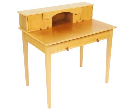 A light oak lady's writing table, the rear superstructure, with four square cupboards and drawers, above two frieze drawers, 