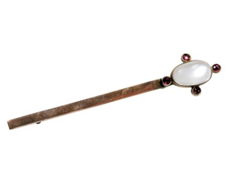 A Victorian moonstone tie pin, set with four rubies at quarters, in rose metal, stamped 9ct, 3.0g.