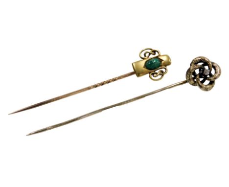 A Victorian diamond set stick pin, in a scroll design, yellow metal, and an Art Nouveau green cabochon set stick pin, in yell