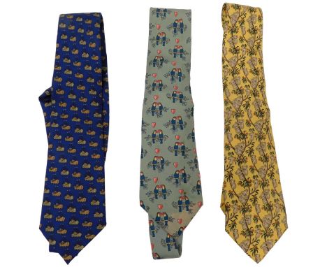 Three Hermes silk ties, comprising a pale green tie with toucans, dark blue tie with fishing vessels, and a yellow tie with k
