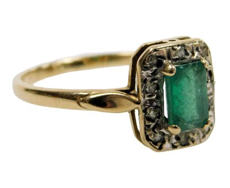 A 9ct gold emerald and diamond ring, the emerald cut stone in a surround of brilliant cut diamonds, size Q, 2.1g.