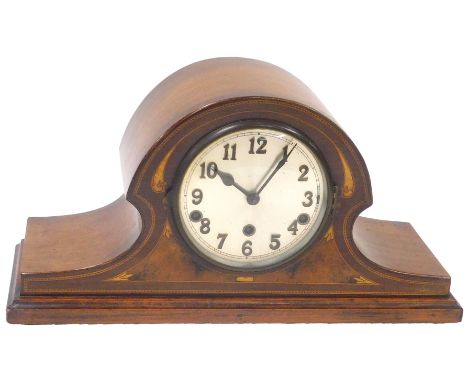 An early 20thC mahogany cased mantel clock, with walnut and mother of pearl inlay, circular silvered dial bearing Arabic nume