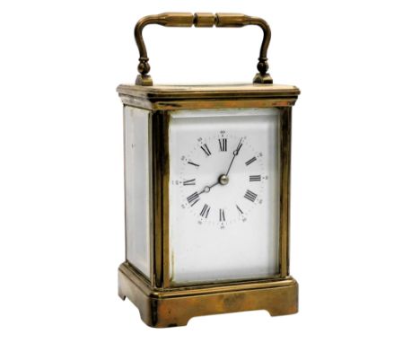 A French brass cased carriage clock, rectangular enamel dial bearing Roman numerals, single barrel movement, the case of conv
