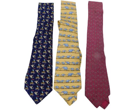 Three Hermes silk ties, comprising a yellow tie with elephants, a pink tie with a geometric pattern, and a dark blue tie with