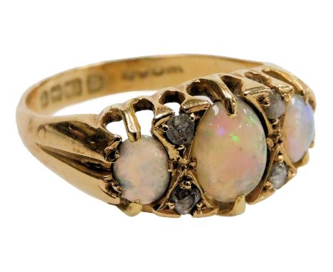 An 18ct gold and opal three stone ring, set with pairs of old cut diamonds at intervals, size M½, 3.4g. 
