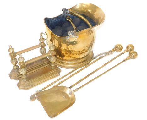 A Victorian brass helmet shaped coal bucket, with a pair of coal tongs, and coal, together with pair of hand irons and three 