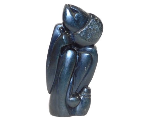 An African stone carving, of a crouching woman by a cooking pot, 44cm high.