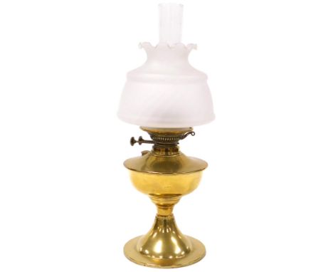 An early 20thC brass oil lamp, with a glass chimney and frosted glass shade, 53cm high. 