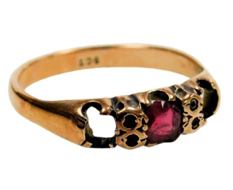 A three stone ring, set with a central ruby, flanking stones lacking, in rose metal, stamped 9ct, size P, 1.8g. 