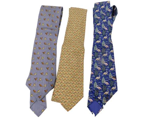 Three Hermes silk ties, comprising a grey tie with chickens and origami, a yellow tie with flowers, and a dark blue tie with 