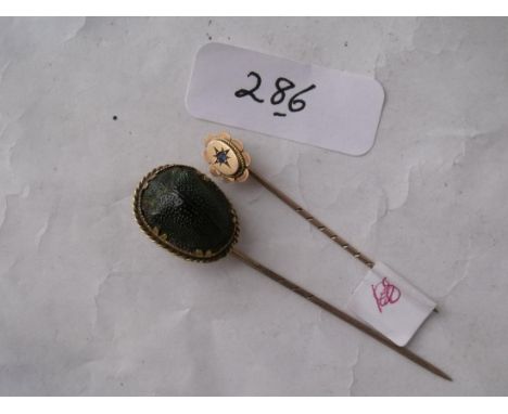 Two 9ct stick pins one of a scarab and one with  a sapphire        