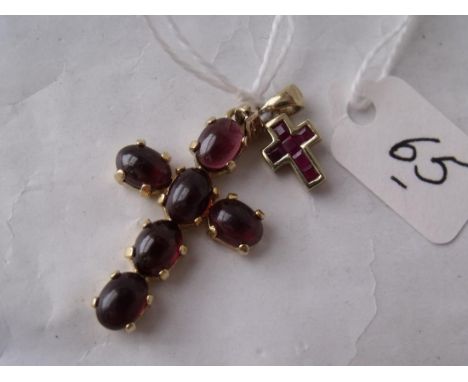 A 9ct cross set with caberchon garnet stones 3cm long  also a very small ruby & gold mounted cross    