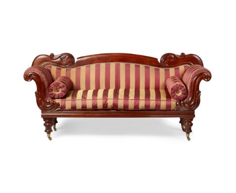 EARLY VICTORIAN MAHOGANY SOFA  MID 19TH CENTURY   the arched back with foliate carving, above a long cushion seat with bolste