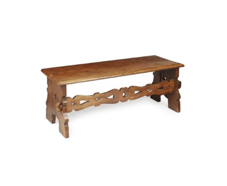 ARTS & CRAFTS OAK HALL BENCH  EARLY 20TH CENTURY   with moulded seat above shaped supports linked by a pierced and chamfered 