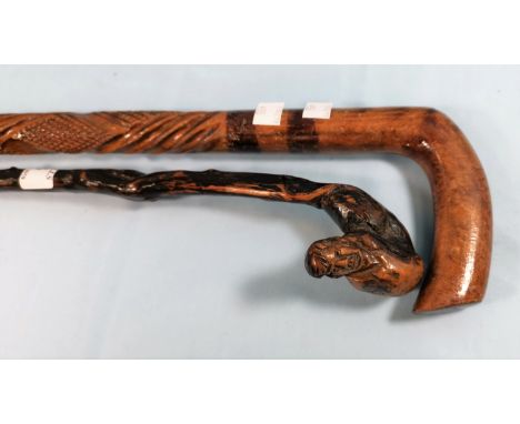 A vintage walking stick with carved head finial and another 