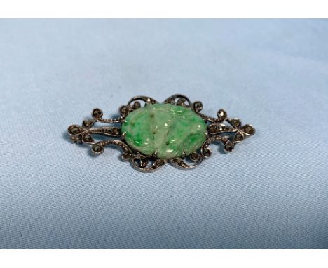 A 1920s brooch set pierced green jade plaque and marcasites 