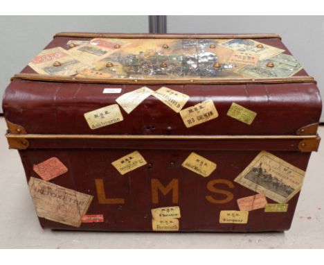 A metal travelling trunk with vintage effect labels 