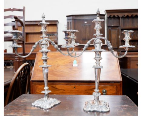 A pair of Georgian style 3 branch candelabra, silver on copper with scroll and acanthus relief decoration, on shaped square b