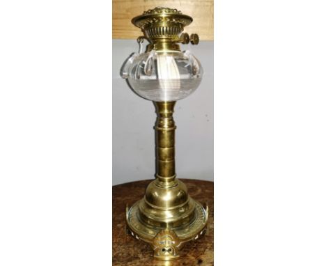 A heavy brass column oil lamp with glass reservoir with drip decoration