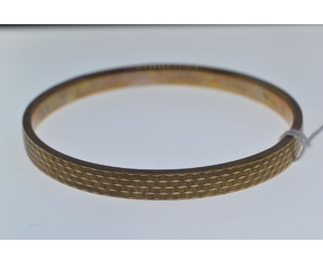 9ct gold bangle, with engine turned decoration, inner diameter 72mm, 9.89 grams 