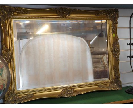 Bevelled mirror with ornate gilt frame 94cm x 68cm Glass is silvered