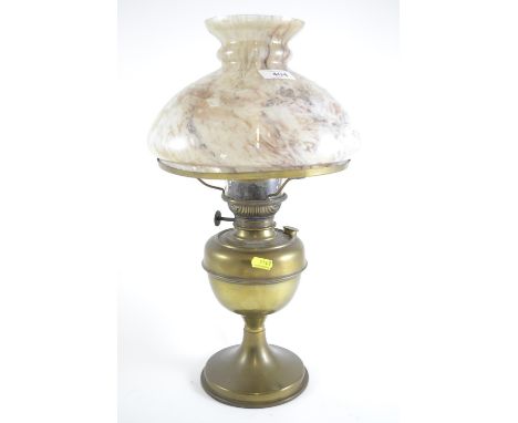 Paraffin lamp with brass base and marbled glass shade. Height 47cm