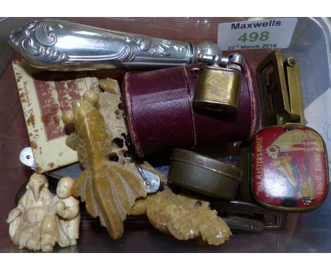 An oriental carved ivory figure group; a stone carving; a brass folding linen glass; a matchbox cover Norwich Victoria FC; a 