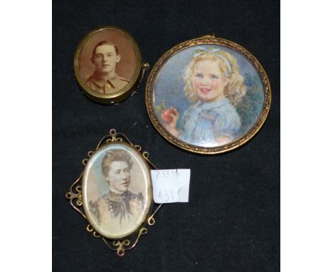 A 1920's miniature portrait of a girl with apple; 2 other photo lockets