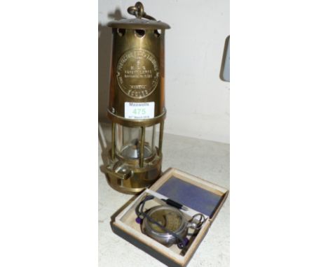 A brass miner’s lamp by Protector Lamplighting, Eccles; a boxed voltmeter