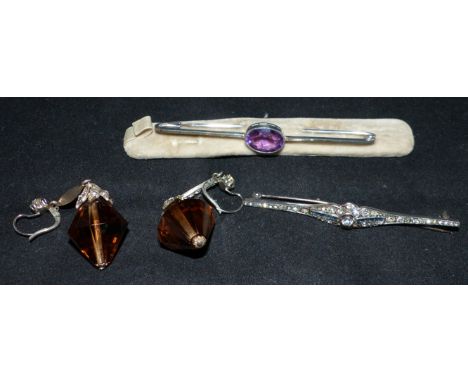 An Art Deco bar brooch; an amethyst set bar brooch; a very large unmounted smoky quartz; 2 smaller stones; similar earrings