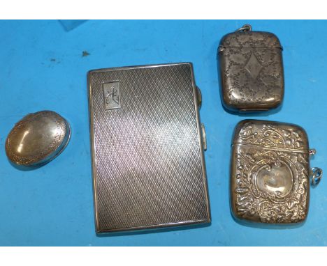 A Victorian silver Vesta case; a modern similar; a hallmarked silver cigarette case; another item