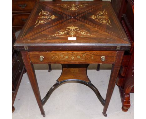 An Edwardian rosewood envelope card table with extensive marquetry inlay, frieze drawer, undertier and square top legs