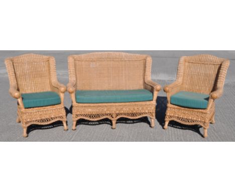 A caned two seat sofa and two matching armchairs