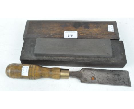 A large chisel and an oak cased sharpener