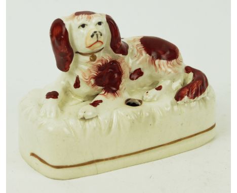 A 19th century Staffordshire inkwell, modelled as a spaniel, 9cm high x 12cm wide