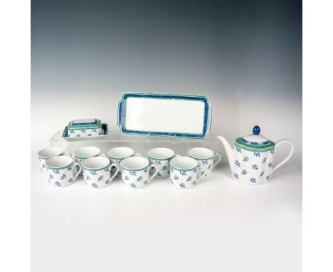 An oblong porcelain teapot with 10 porcelain teacups, a butter dish, and a serving tray. All the items share the same design 