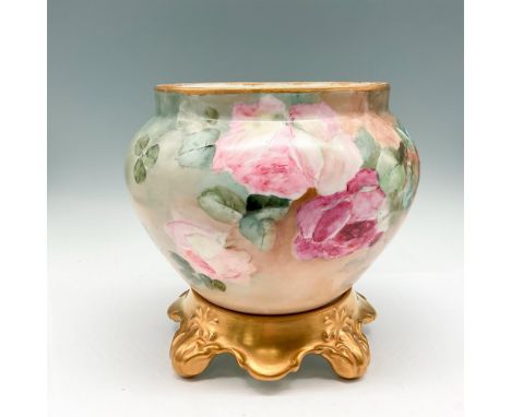 Hand painted floral design on cream colored background with gilt top rim. This item has a porcelain gilt stand included: 6"L 