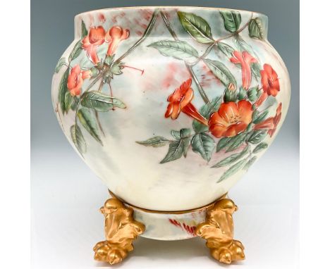 Lovely hand painted raised floral and leaf design colored in orange and green on cream background with gilt rim. This item ha