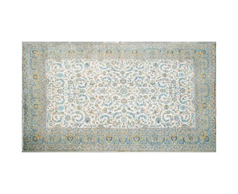 A stunning teal and beige woven rug with yellow accents. Decorated with detailed flowers and scrolling acanthus leaves. Short