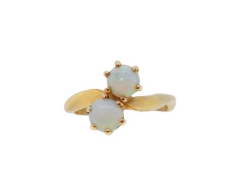 A two stone opal crossover ring, size H, stamped '14K', weight 2.6g
